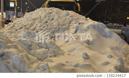 Snow pile on city street at night after blizzard, winter clean-up concept Snow pile on city street at night after blizzard, winter clean-up concept 138229417