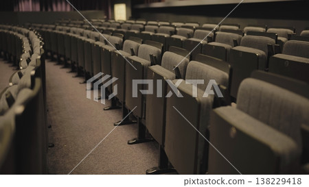 Empty seats curving in an auditorium, highlighting the concept of vacancy and waiting 138229418