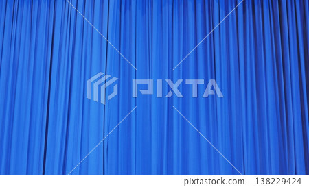 Blue theater curtain with vertical folds creating a dynamic texture backdrop Blue theater curtain with vertical folds creating a dynamic texture backdrop 138229424