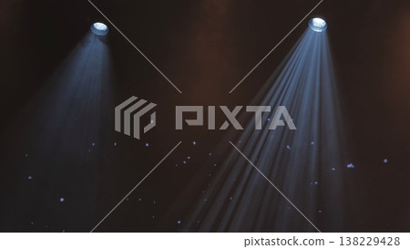 Two bright spotlights shining on a dark stage creating dramatic light beams with haze Two bright spotlights shining on a dark stage creating dramatic light beams with haze 138229428