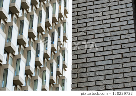 Modern building geometry meeting traditional brick wall texture in urban design Modern building geometry meeting traditional brick wall texture in urban design 138229722