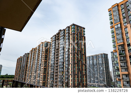 Modern residential complex featuring tall apartment buildings creating urban panorama Modern residential complex featuring tall apartment buildings creating urban panorama 138229726