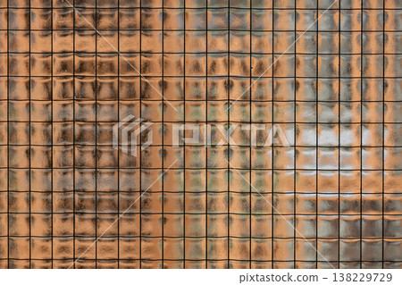 Textured wired glass surface creating abstract pattern with light and shadow reflections 138229729