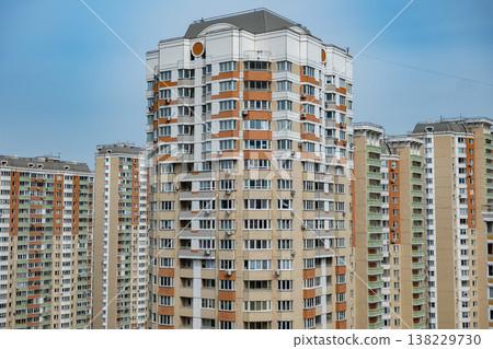Modern residential multistory buildings creating an urban city skyline against blue sky 138229730