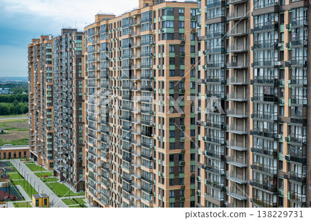 Modern residential complex featuring multiple high-rise apartment buildings and green spaces 138229731