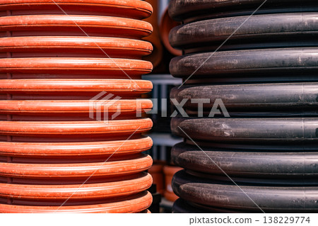 Corrugated plastic pipes showing a construction industry and building material concept Corrugated plastic pipes showing a construction industry and building material concept 138229774