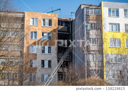 Fire damaged residential building showing charred balconies and a rescue ladder Fire damaged residential building showing charred balconies and a rescue ladder 138229815