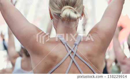 Woman practicing yoga warrior pose during sports day 138229914