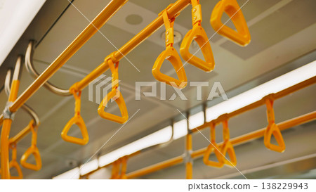 Yellow hanging handles inside Moscow metro train providing public transport 138229943
