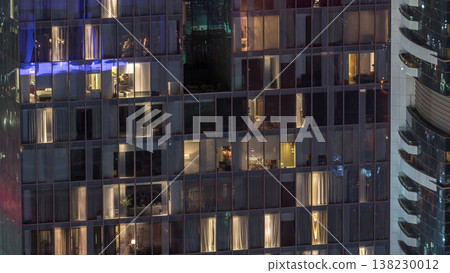 Night view of exterior apartment tower timelapse. High rise skyscraper with blinking lights in windows Night view of exterior apartment tower timelapse. High rise skyscraper with blinking lights in windows 138230012