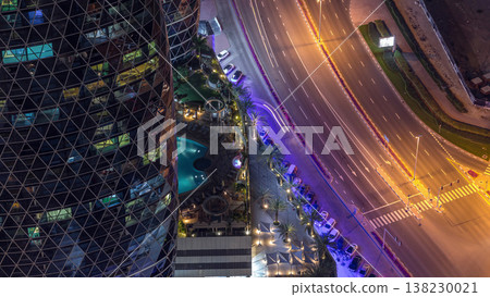 Skyline view of intersection traffic on Al Saada street near DIFC night timelapse in Dubai, UAE. Skyline view of intersection traffic on Al Saada street near DIFC night timelapse in Dubai, UAE. 138230021