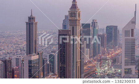 Skyline of the buildings of Sheikh Zayed Road and DIFC aerial night to day timelapse in Dubai, UAE. Skyline of the buildings of Sheikh Zayed Road and DIFC aerial night to day timelapse in Dubai, UAE. 138230035