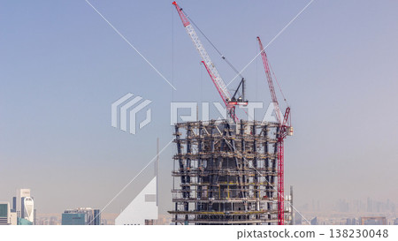 Construction of new modern skyscraper in Dubai city aerial timelapse, United Arab Emirates 138230048