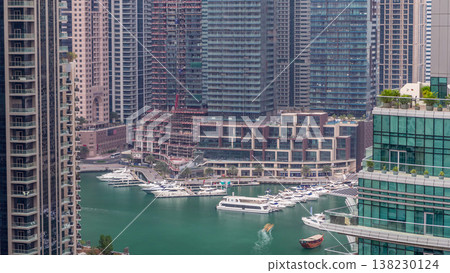 Aerial view of Dubai Marina residential and office skyscrapers with waterfront timelapse Aerial view of Dubai Marina residential and office skyscrapers with waterfront timelapse 138230124