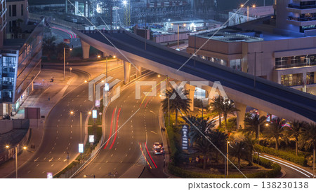 Aerial view to Dubai marina street with construction site on background night timelapse. 138230138