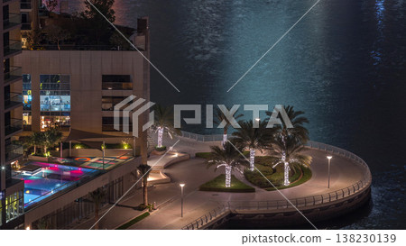 Waterfront promenade in Dubai Marina aerial night timelapse. Dubai, United Arab Emirates Waterfront promenade in Dubai Marina aerial night timelapse. Dubai, United Arab Emirates 138230139