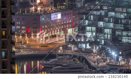 Waterfront promenade in Dubai Marina aerial night timelapse. Dubai, United Arab Emirates 138230140