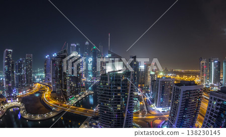 Aerial view of Dubai Marina residential and office skyscrapers with waterfront night timelapse 138230145