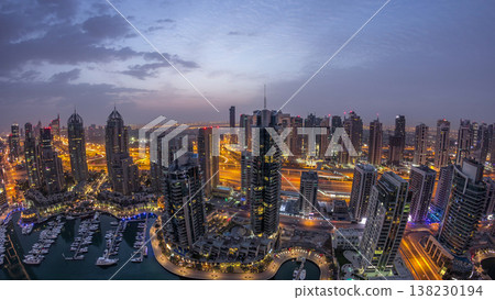 Aerial top view of Dubai Marina night to day timelapse. Modern towers and traffic on the road Aerial top view of Dubai Marina night to day timelapse. Modern towers and traffic on the road 138230194