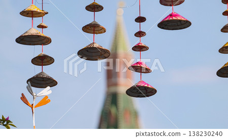 Vietnamese conical hats hanging with Kremlin tower in background celebrating cultural exchange 138230240
