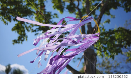 Purple ribbons fluttering in wind, celebrating India Day festival in Moscow park Purple ribbons fluttering in wind, celebrating India Day festival in Moscow park 138230262