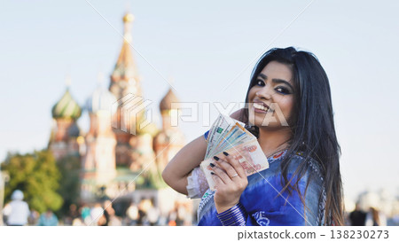 Young Indian woman holding Russian rubles in Moscow Young Indian woman holding Russian rubles in Moscow 138230273