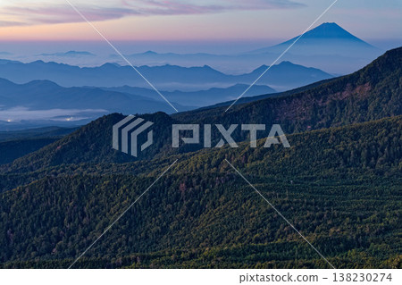 Mount Fuji at dawn and the mountain range shrouded in morning mist, as seen from Nyū in the northern Yatsugatake Mountains. Mount Fuji at dawn and the mountain range shrouded in morning mist, as seen from Nyū in the northern Yatsugatake Mountains. 138230274