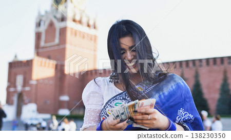 Young Indian woman counting money in Moscow 138230350
