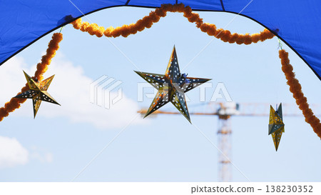India Day street festival decorations with marigold garlands and star lanterns against clear sky 138230352