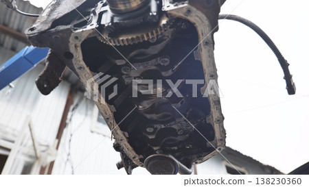 Disassembled car engine block showing crankshaft during automotive repair in workshop Disassembled car engine block showing crankshaft during automotive repair in workshop 138230360