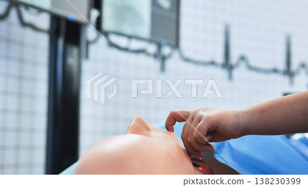 Student hand performing chest compressions on a dummy for medical emergency training Student hand performing chest compressions on a dummy for medical emergency training 138230399
