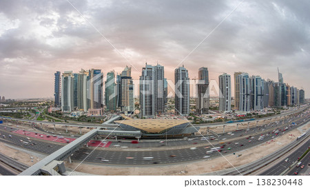 Aerial top view to Sheikh Zayed road near Dubai Marina and JLT day to night timelapse, Dubai. Aerial top view to Sheikh Zayed road near Dubai Marina and JLT day to night timelapse, Dubai. 138230448