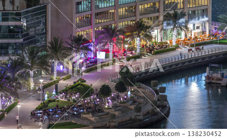 Waterfront promenade in Dubai Marina aerial night timelapse. Dubai, United Arab Emirates Waterfront promenade in Dubai Marina aerial night timelapse. Dubai, United Arab Emirates 138230452