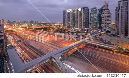 Aerial top view to Sheikh Zayed road near Dubai Marina and JLT day to night timelapse, Dubai. Aerial top view to Sheikh Zayed road near Dubai Marina and JLT day to night timelapse, Dubai. 138230457