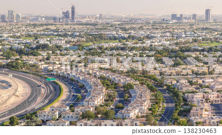 Aerial view to villas and houses with Golf course with green lawn and lakes timelapse Aerial view to villas and houses with Golf course with green lawn and lakes timelapse 138230463
