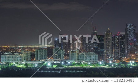 Jumeirah lake towers skyscrapers and golf course night timelapse, Dubai, United Arab Emirates Jumeirah lake towers skyscrapers and golf course night timelapse, Dubai, United Arab Emirates 138230495
