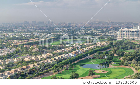 Aerial view to villas and houses with Golf course with green lawn and lakes timelapse Aerial view to villas and houses with Golf course with green lawn and lakes timelapse 138230509