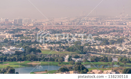 Aerial view to villas and houses with Golf course with green lawn and lakes timelapse Aerial view to villas and houses with Golf course with green lawn and lakes timelapse 138230518