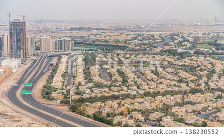 Aerial view of apartment houses and villas in Dubai city timelapse, United Arab Emirates Aerial view of apartment houses and villas in Dubai city timelapse, United Arab Emirates 138230552