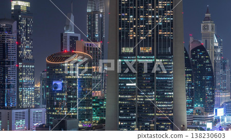 Aerial view on downtown and financial district in Dubai night timelapse, United Arab Emirates with skyscrapers and highways. Aerial view on downtown and financial district in Dubai night timelapse, United Arab Emirates with skyscrapers and highways. 138230603