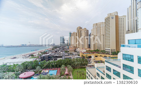 Aerial view of beach and tourists walking and sunbathing on holiday in JBR timelapse in Dubai, UAE 138230610