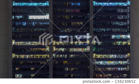 Office windows on facade of a modern skyscraper showing business activity 138230652