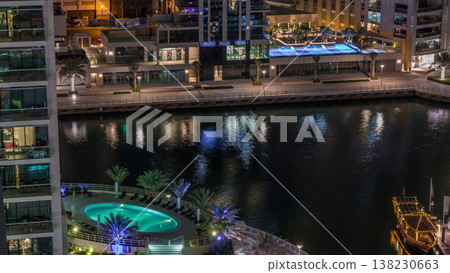Waterfront promenade in Dubai Marina aerial night timelapse. Dubai, United Arab Emirates 138230663