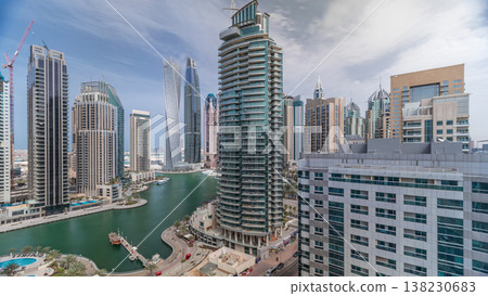 Aerial view of Dubai Marina residential and office skyscrapers with waterfront timelapse Aerial view of Dubai Marina residential and office skyscrapers with waterfront timelapse 138230683