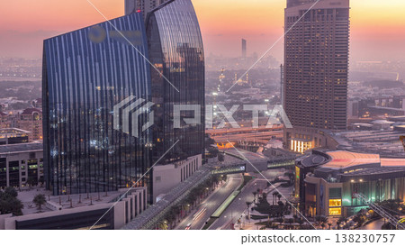 Dubai downtown street with busy traffic and skyscrapers around night to day timelapse. Dubai downtown street with busy traffic and skyscrapers around night to day timelapse. 138230757