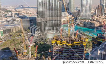 Aerial view of a skyscraper under construction with huge cranes timelapse in Dubai. Aerial view of a skyscraper under construction with huge cranes timelapse in Dubai. 138230772