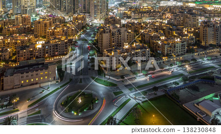 Aerial view of a roundabout circle road in Dubai downtown from above night timelapse. Dubai, United Arab Emirates. 138230848