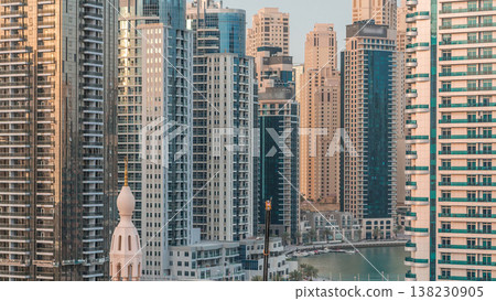 Luxury yachts parked on the pier in Dubai Marina bay with city aerial view timelapse Luxury yachts parked on the pier in Dubai Marina bay with city aerial view timelapse 138230905