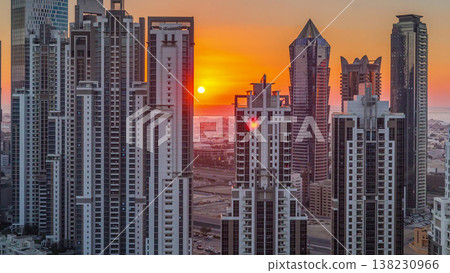 Modern residential and office complex with many towers aerial timelapse at sunset in Business Bay, Dubai, UAE. Modern residential and office complex with many towers aerial timelapse at sunset in Business Bay, Dubai, UAE. 138230966