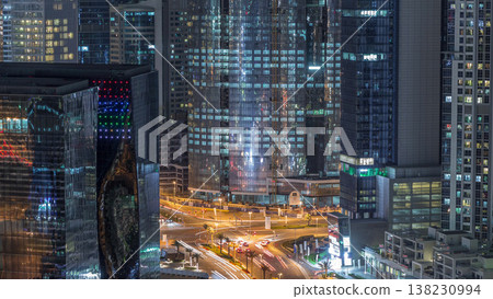 Top view city traffic on a crossroad in Dubai Business bay night timelapse. Top view city traffic on a crossroad in Dubai Business bay night timelapse. 138230994